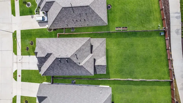 an aerial view of residential houses with outdoor space