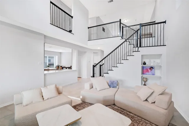 a kitchen with a sink a stove a refrigerator a center island and a window