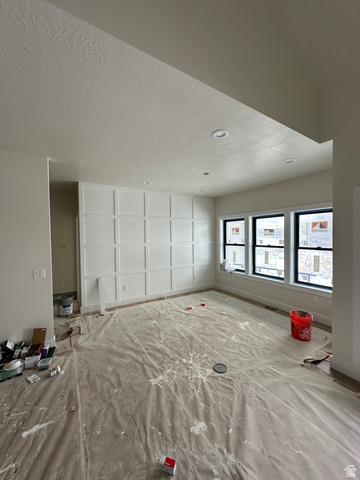 143 South Chamberlain Street, Unit 327 Mapleton, UT 84664 - Photo 5 of 12 Unfurnished room featuring a textured ceiling and baseboards