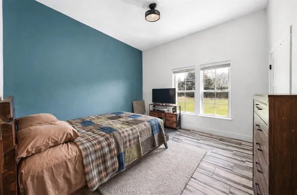 a bedroom with a bed and a television