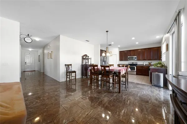 a kitchen with stainless steel appliances granite countertop a refrigerator and a sink