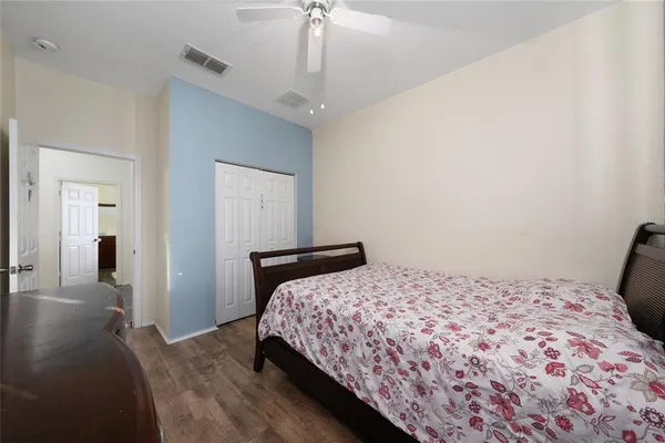 a bathroom with a granite countertop sink a toilet and a mirror