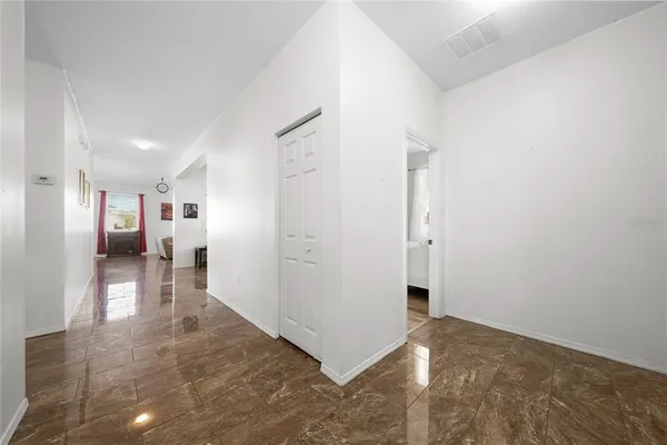 a view of a hallway with closet and wooden floor