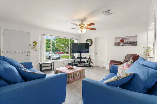 a living room with furniture fireplace and a large window