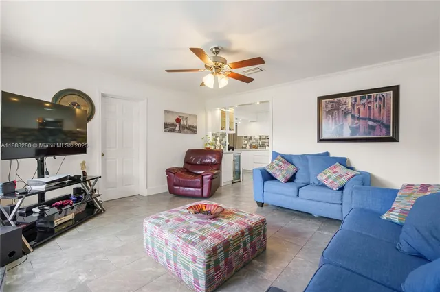 a living room with furniture a flat screen tv and a couch