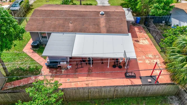 an aerial view of a house with wooden fence