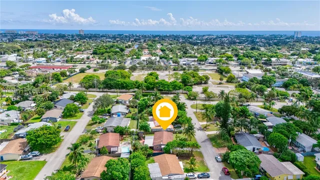 an aerial view of residential houses with outdoor space and lake view