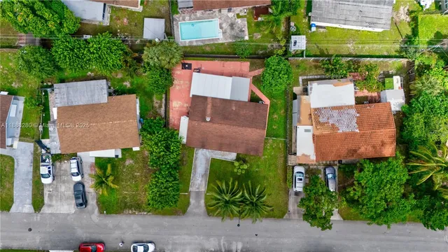 an aerial view of multiple houses with yard
