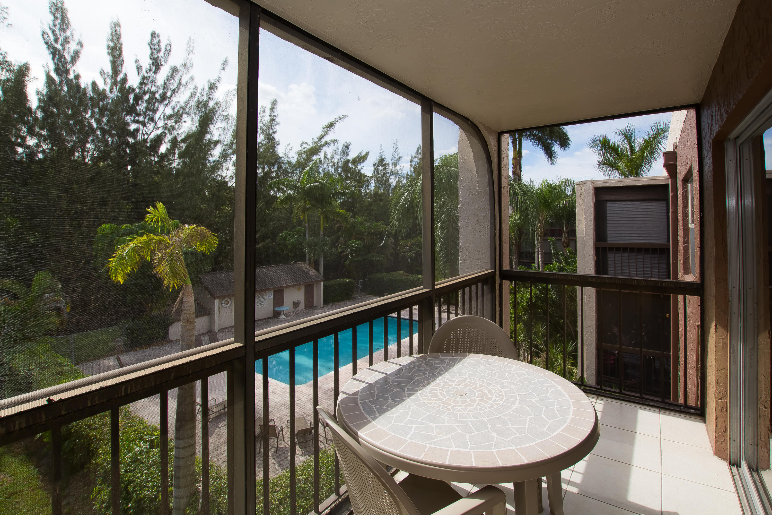 a view of a balcony with a table and chairs