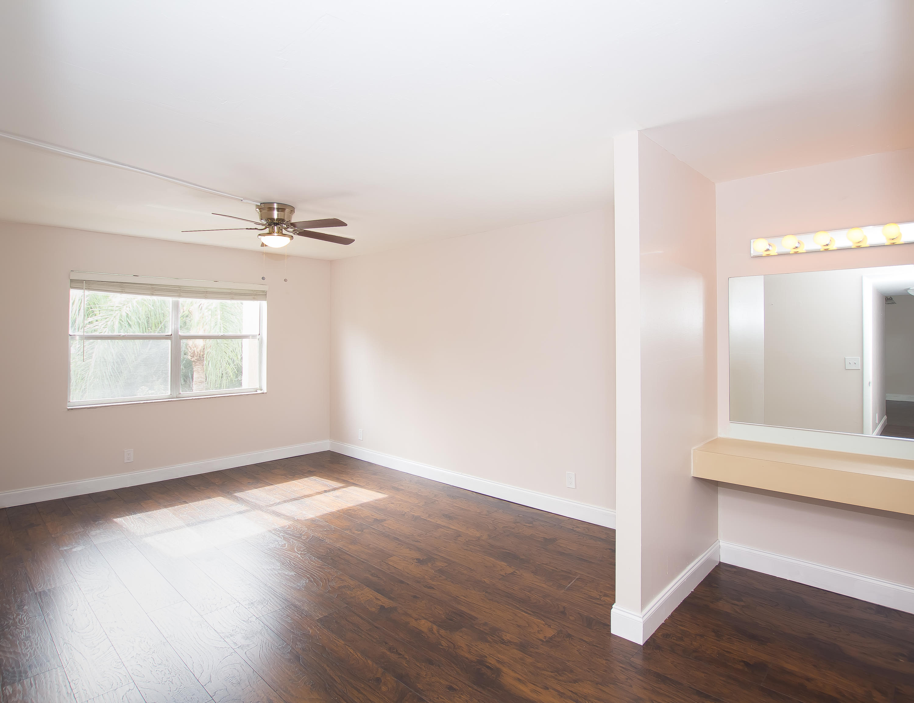 7080 Nova Drive, Unit 306B Davie, FL 33317 - Photo 11 of 25 an empty room with wooden floor cabinet and windows