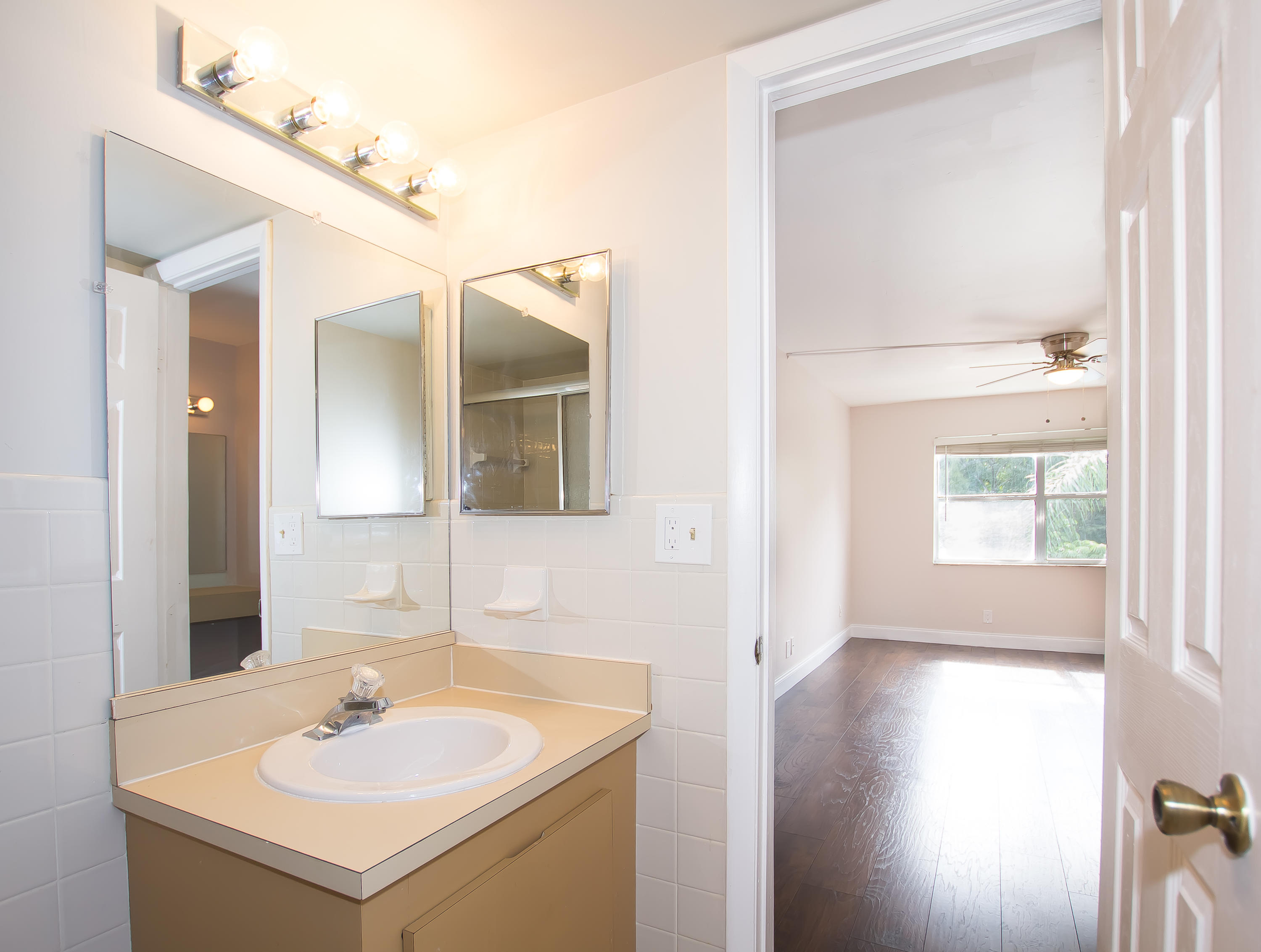 7080 Nova Drive, Unit 306B Davie, FL 33317 - Photo 15 of 25 a bathroom with a sink and a mirror