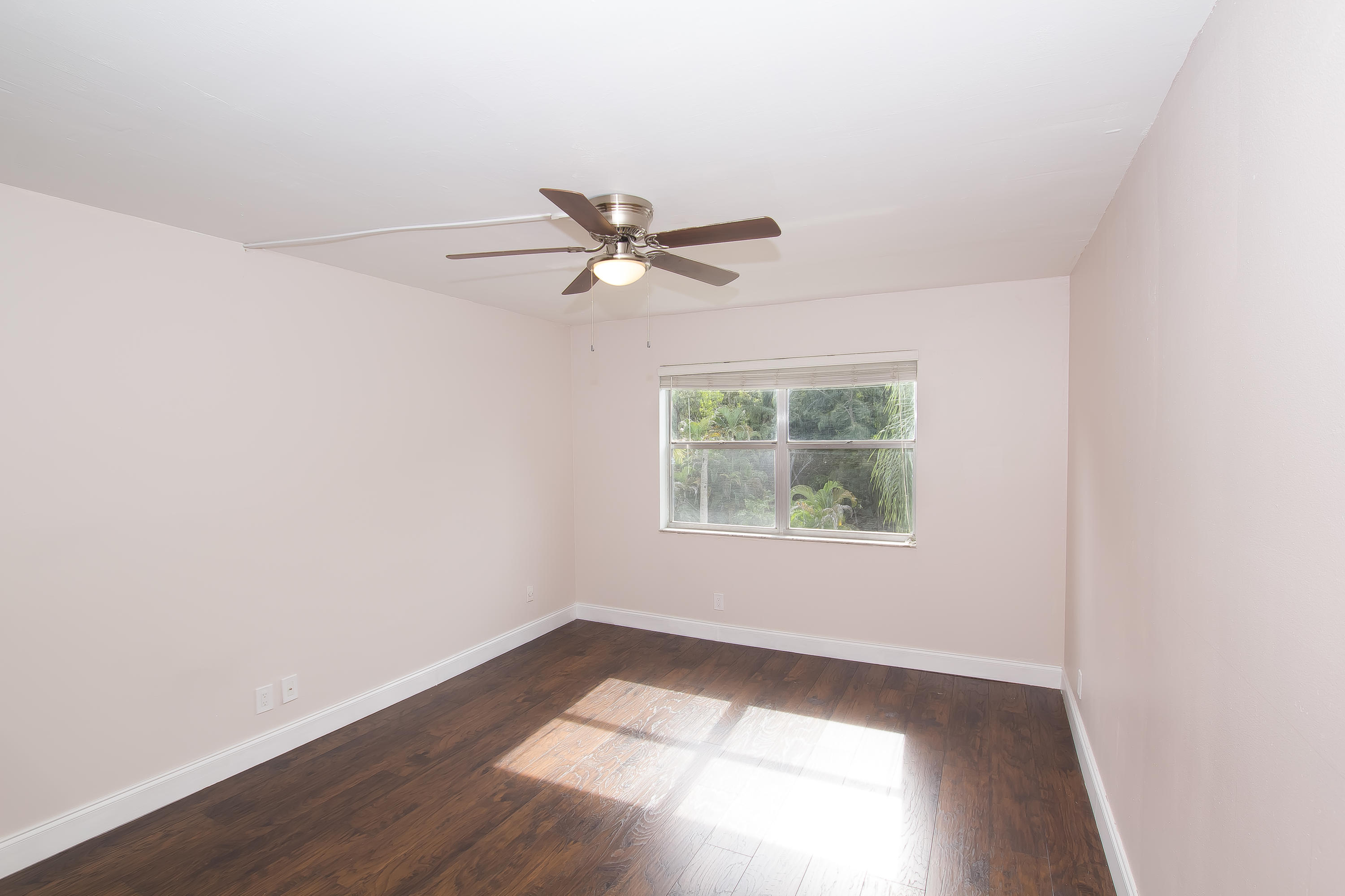 7080 Nova Drive, Unit 306B Davie, FL 33317 - Photo 19 of 25 an empty room with wooden floor and windows