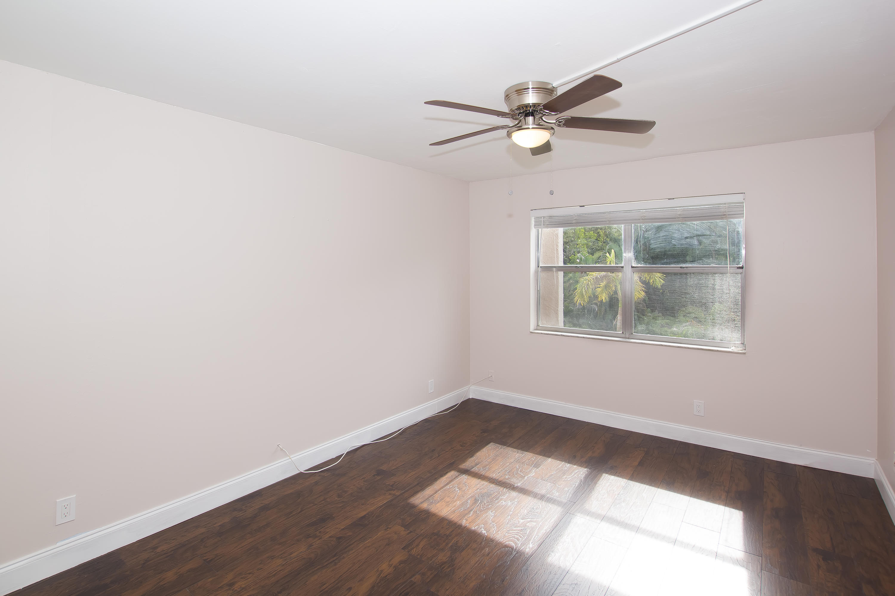 7080 Nova Drive, Unit 306B Davie, FL 33317 - Photo 20 of 25 a view of an empty room with wooden floor and a window