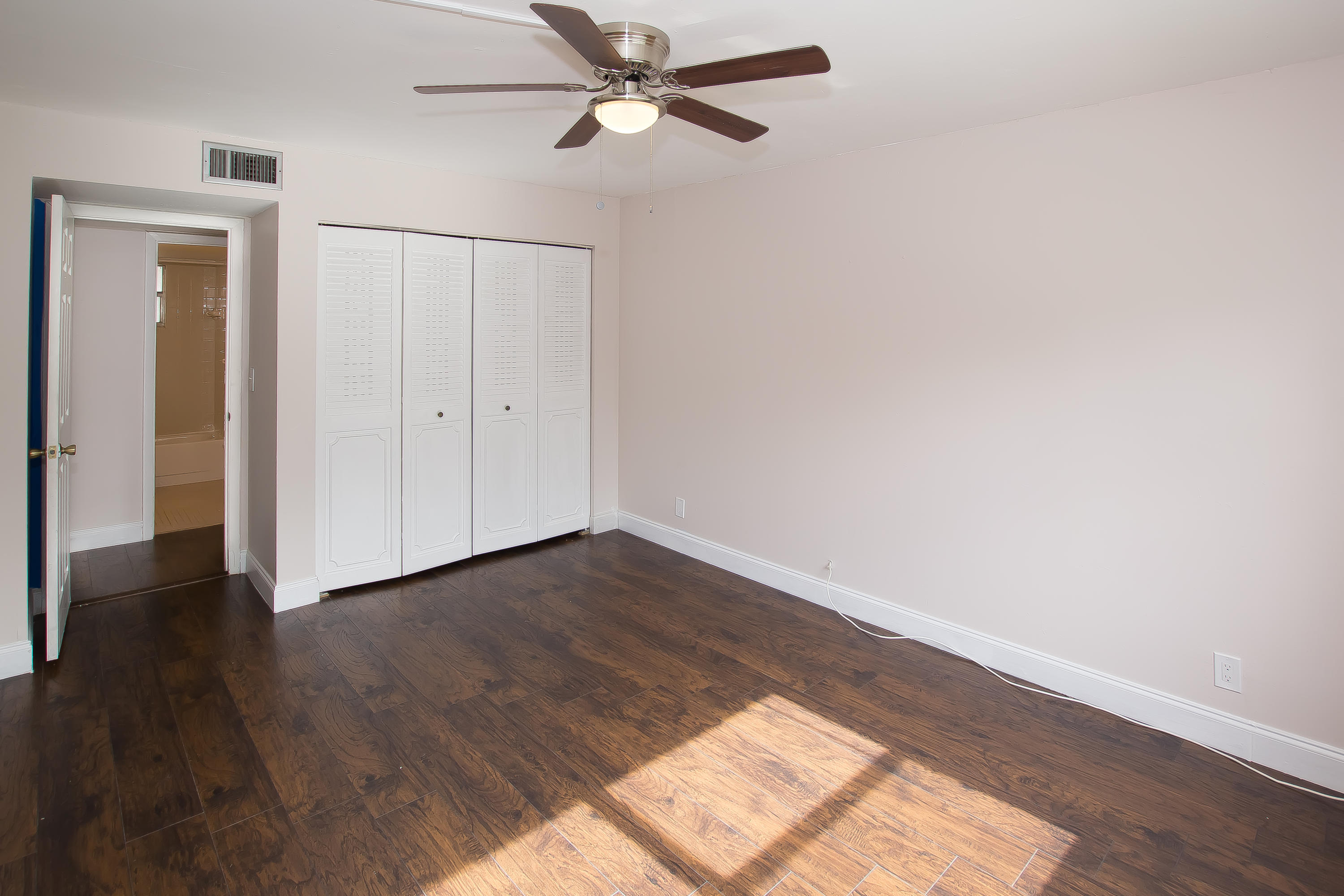 7080 Nova Drive, Unit 306B Davie, FL 33317 - Photo 21 of 25 an empty room with wooden floor closet and windows