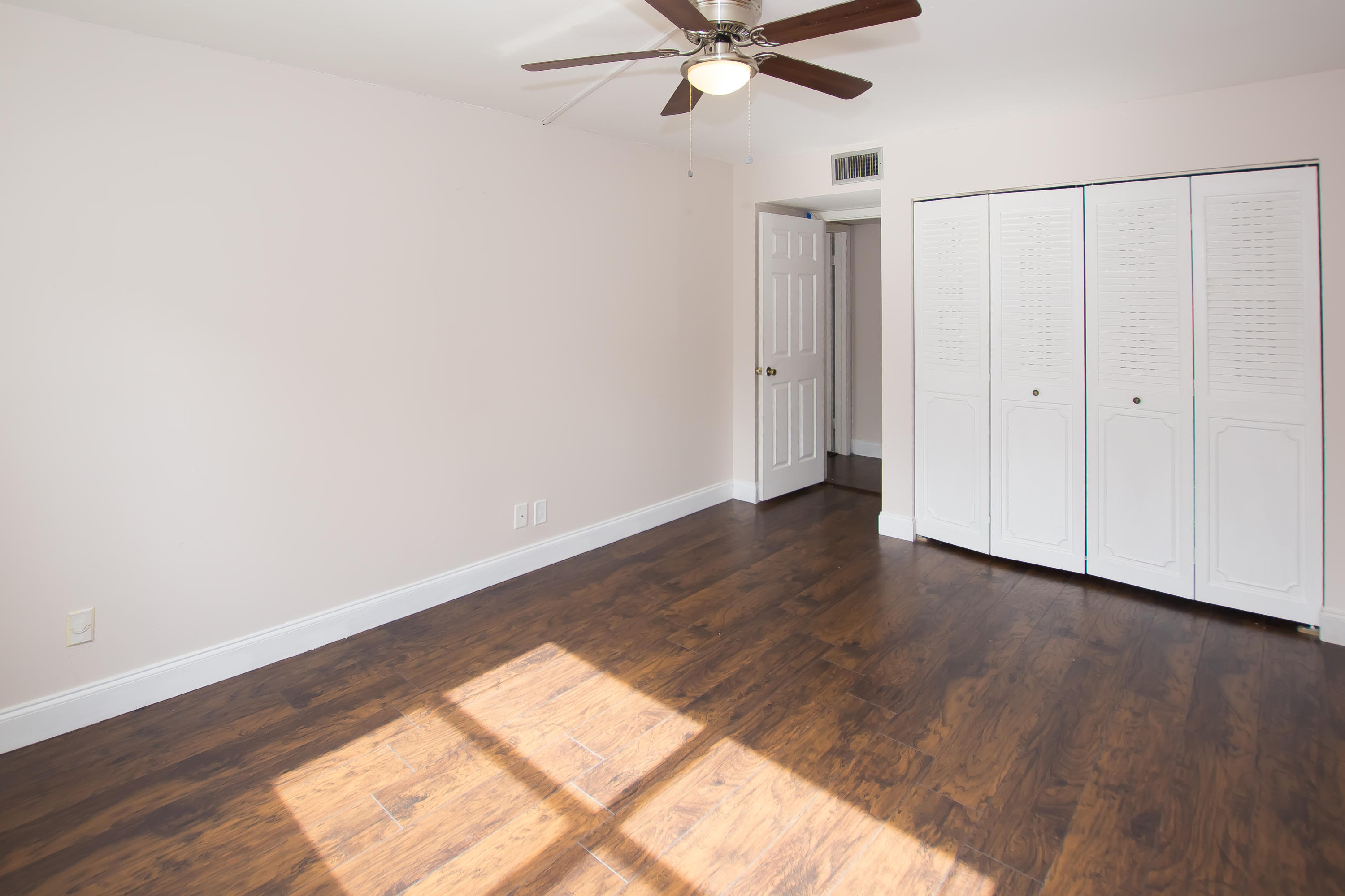 7080 Nova Drive, Unit 306B Davie, FL 33317 - Photo 22 of 25 a view of a room with wooden floor staircase and a ceiling fan