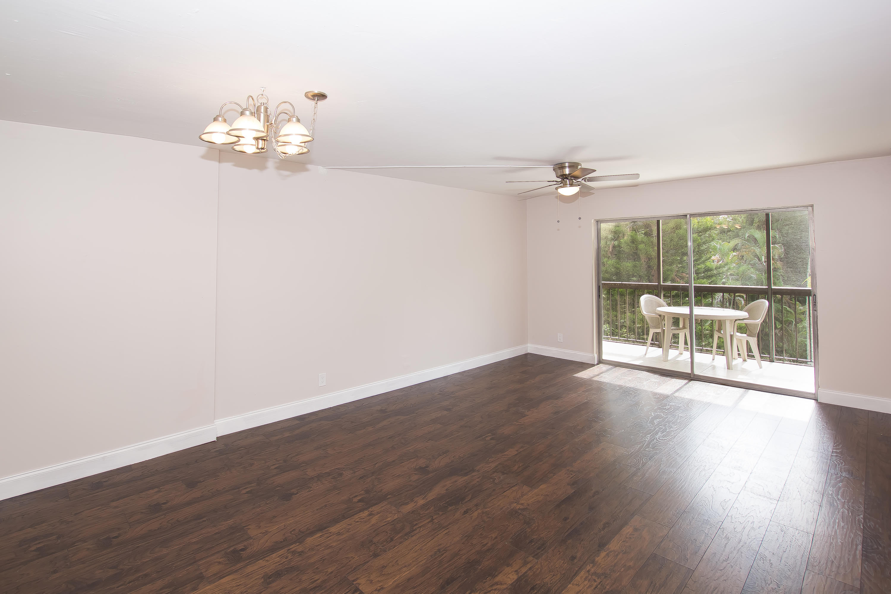 7080 Nova Drive, Unit 306B Davie, FL 33317 - Photo 4 of 25 a view of an empty room with wooden floor and a window
