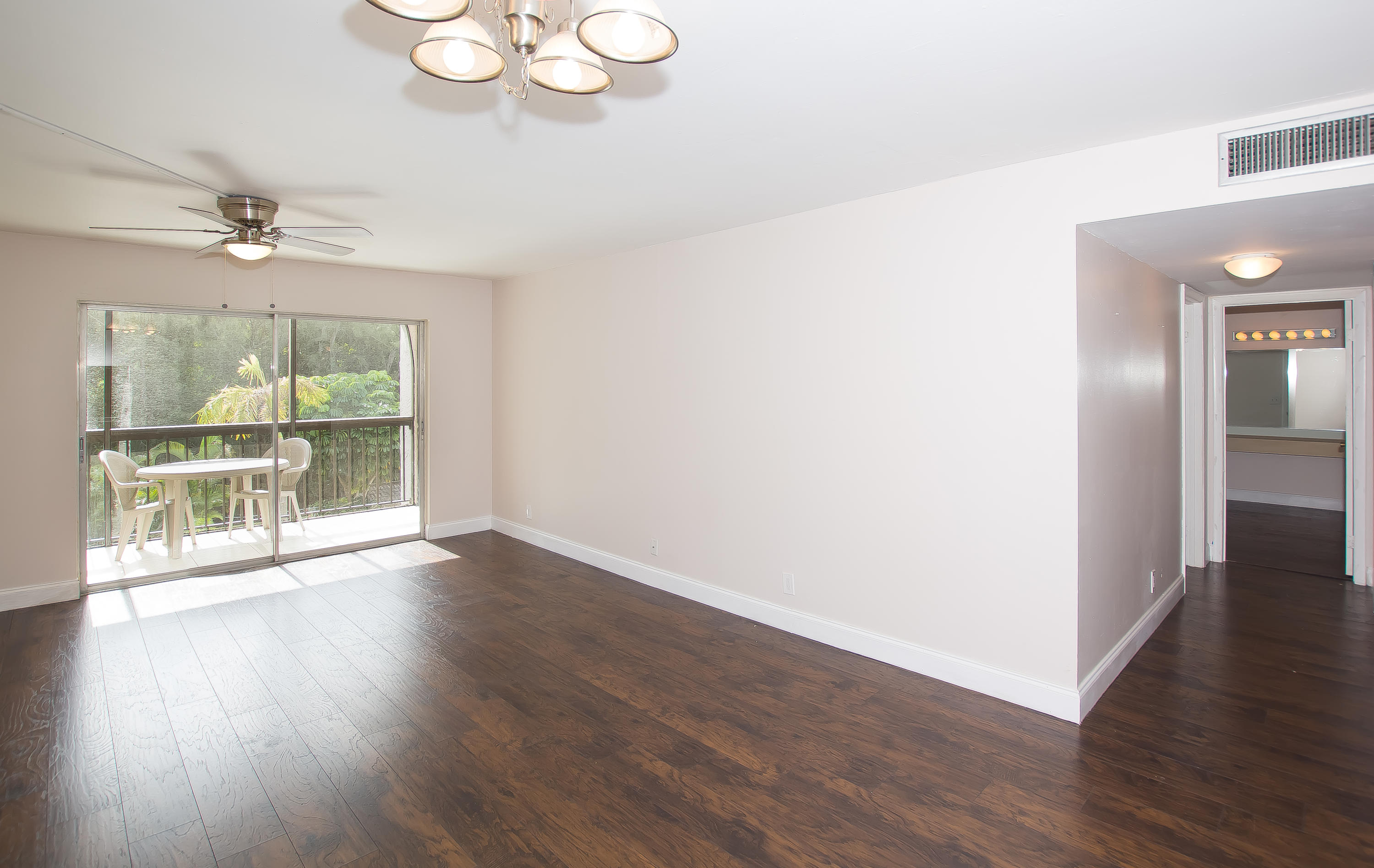 7080 Nova Drive, Unit 306B Davie, FL 33317 - Photo 6 of 25 a view of an empty room with wooden floor and a window