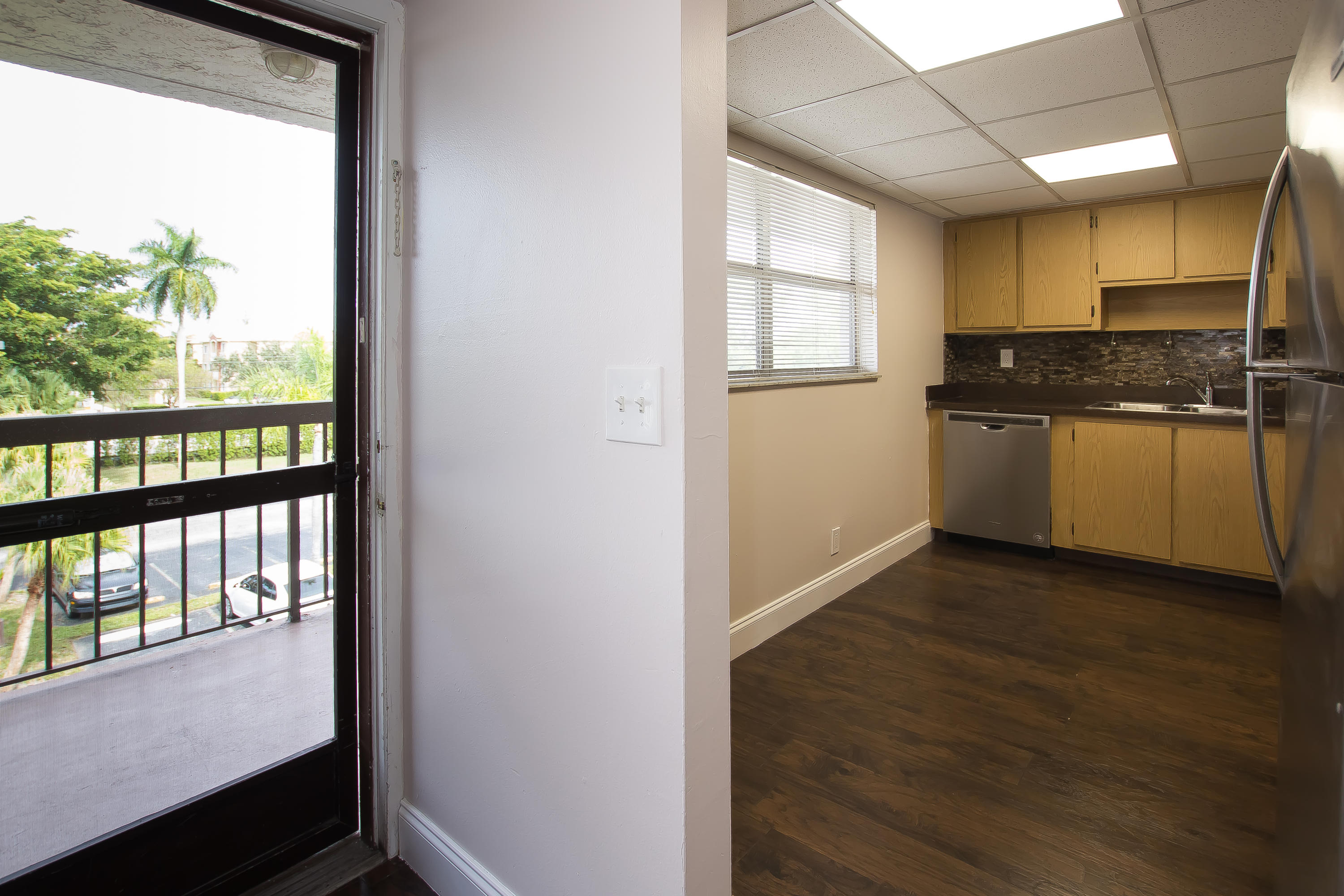 7080 Nova Drive, Unit 306B Davie, FL 33317 - Photo 9 of 25 a kitchen with a window a sink and a refrigerator