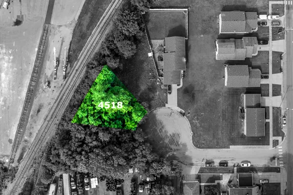 a aerial view of a residential apartment building with a yard