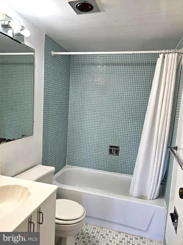a bathroom with a toilet a sink and bathtub