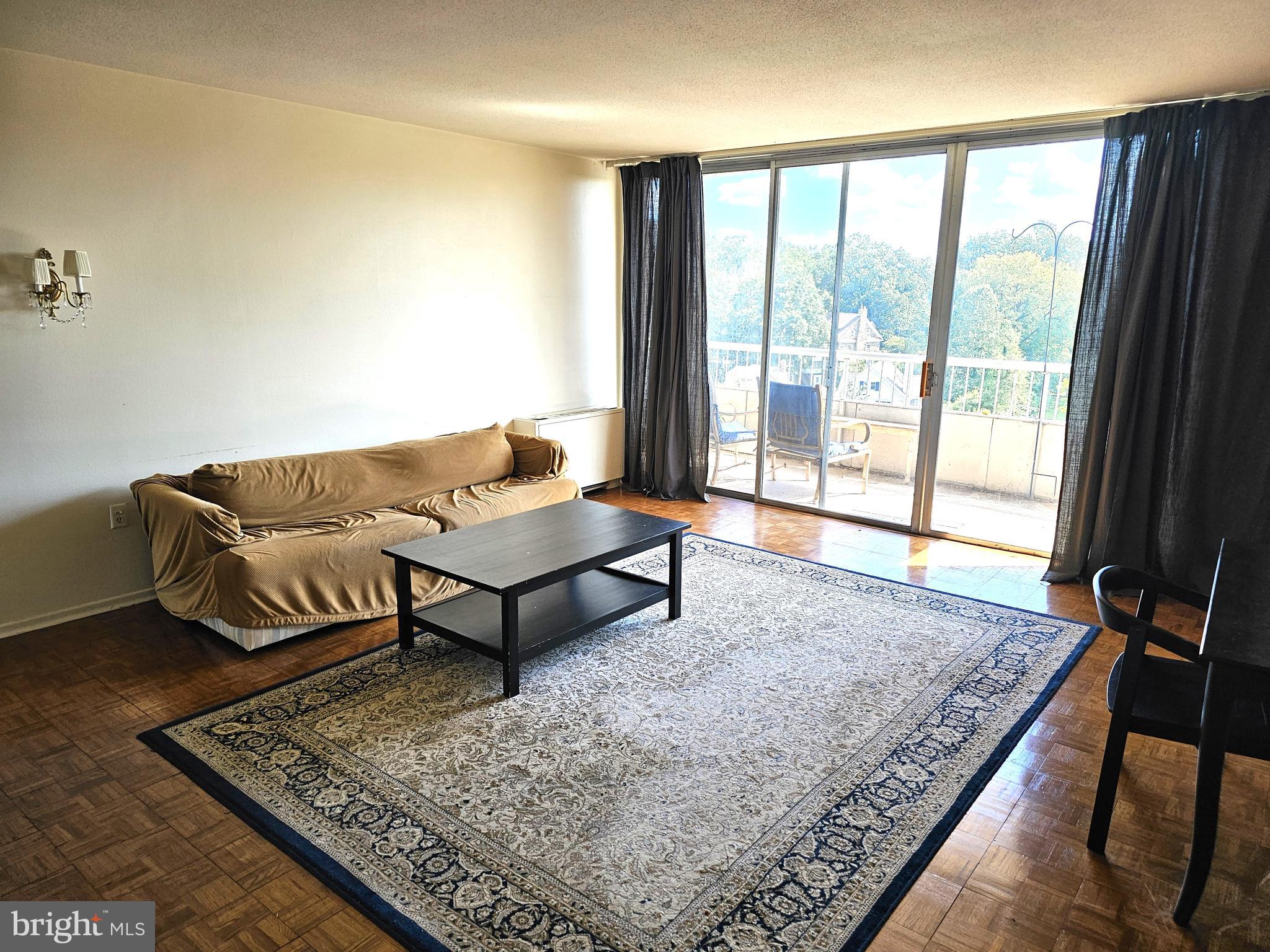 100 West Avenue, Unit 407S Jenkintown, PA 19046 - Photo 3 of 42 a living room with a couch and a rug