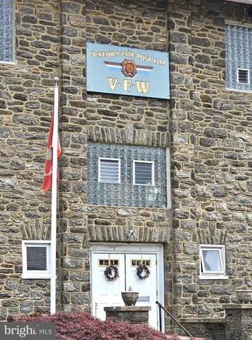 a brick building with a door and a sink