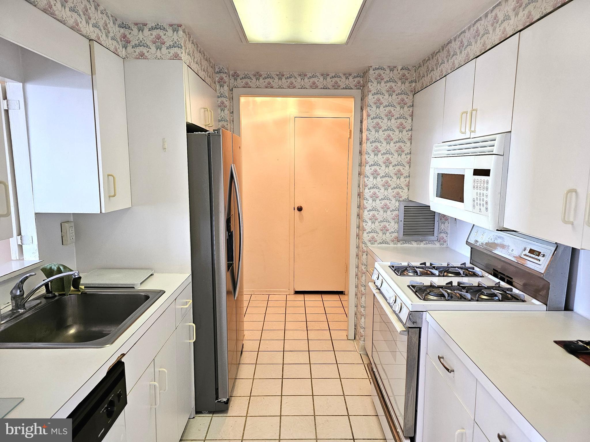 100 West Avenue, Unit 407S Jenkintown, PA 19046 - Photo 7 of 42 a kitchen that has a sink stainless steel appliances a counter space and a window