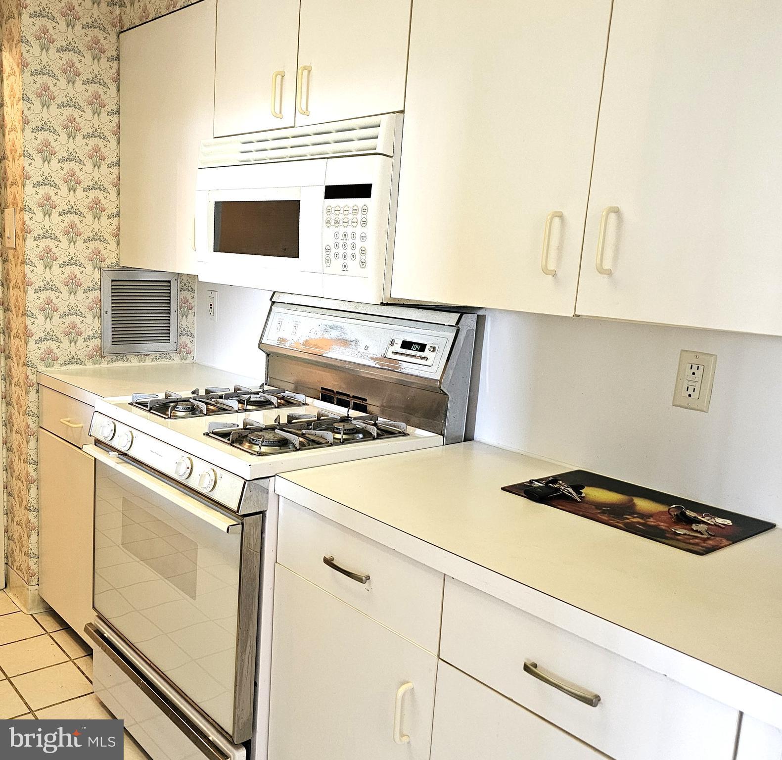 100 West Avenue, Unit 407S Jenkintown, PA 19046 - Photo 8 of 42 a kitchen with a stove and a microwave