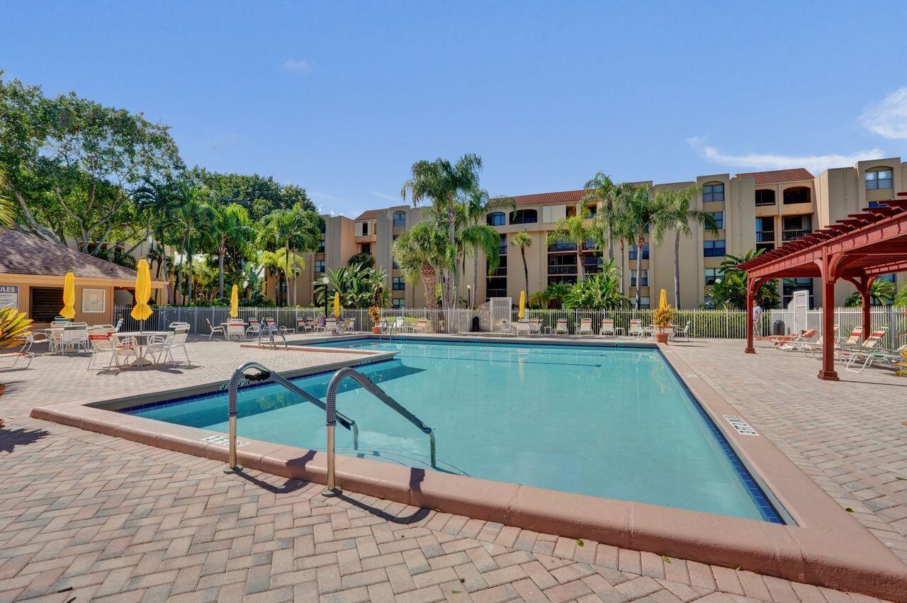 755 Dotterel Road, Unit 1112 Delray Beach, FL 33444 - Photo 47 of 64 a swimming pool with outdoor seating and yard