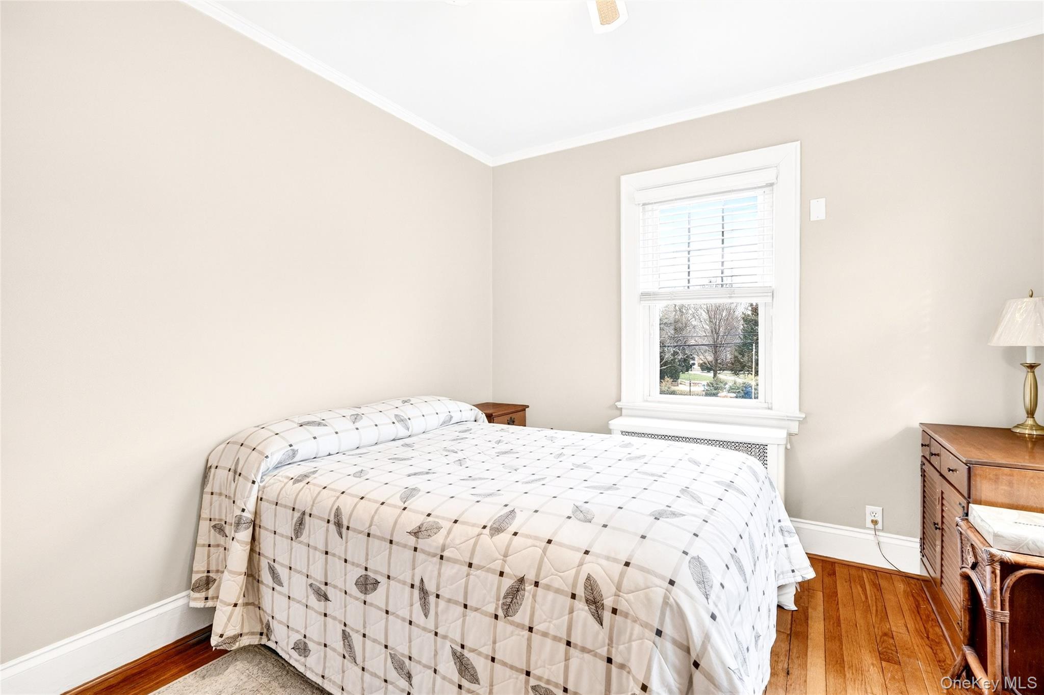 3334 Country Club Road Bronx, NY 10465 - Photo 37 of 49 Bedroom featuring ornamental molding, light wood-style floors, radiator, and a ceiling fan