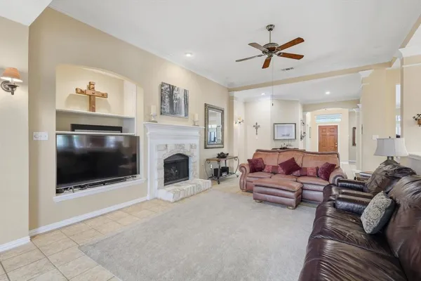 a living room with furniture a fireplace and a flat screen tv