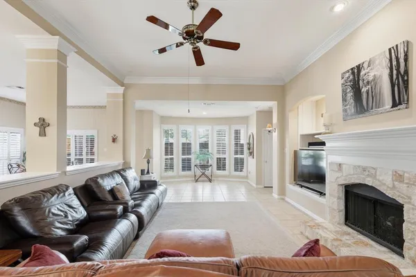 a living room with furniture fireplace and a large window