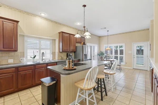 a view of a dining room and livingroom with furniture wooden floor a chandelier