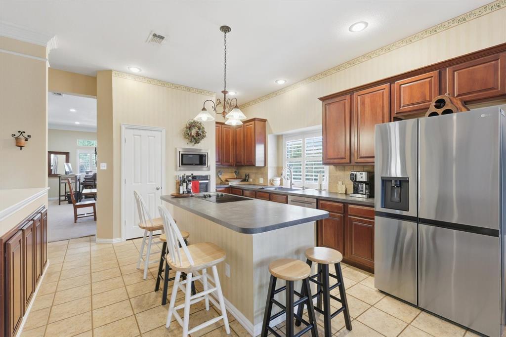 2012 Hayden Lane Corinth, TX 76210 - Photo 18 of 40 a kitchen with stainless steel appliances a sink stove and refrigerator
