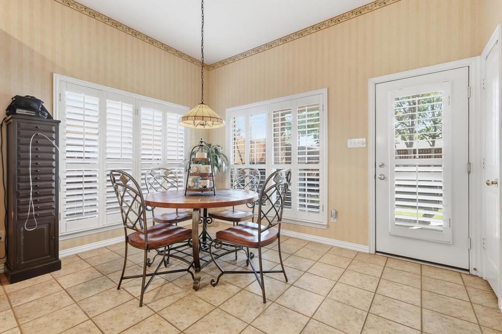 2012 Hayden Lane Corinth, TX 76210 - Photo 21 of 40 a view of a dining room with furniture and chandelier