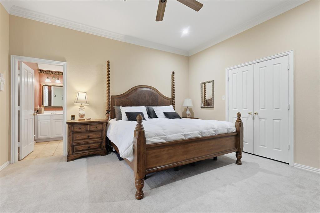 2012 Hayden Lane Corinth, TX 76210 - Photo 24 of 40 a bedroom with a bed and cabinets