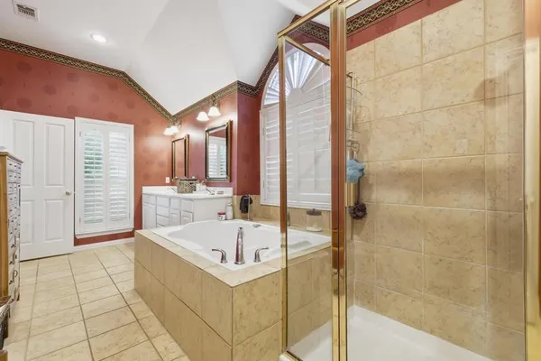 a bathroom with a bathtub and a shower
