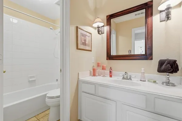 a bathroom with a toilet sitting next to a bathroom sink