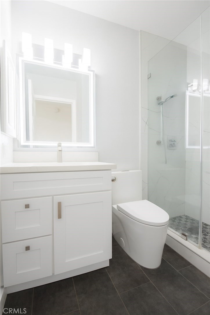 5114 West 1st Street, Unit C Santa Ana, CA 92703 - Photo 14 of 26 a bathroom with a white toilet sink and shower