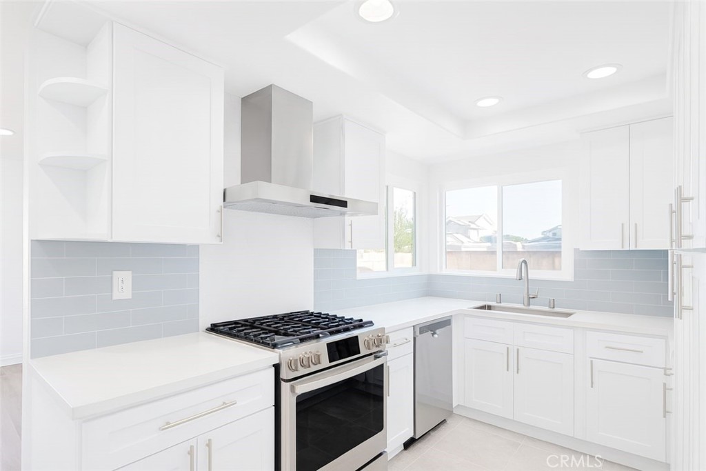 5114 West 1st Street, Unit C Santa Ana, CA 92703 - Photo 3 of 26 a kitchen with white cabinets and white appliances