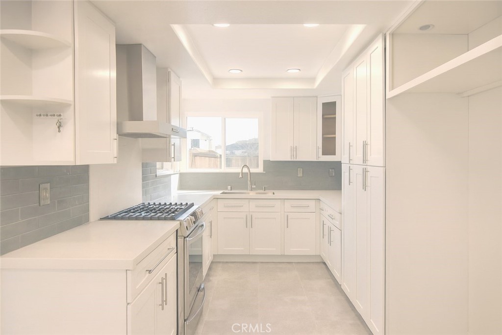 5114 West 1st Street, Unit C Santa Ana, CA 92703 - Photo 5 of 26 a kitchen with a sink stove and cabinets