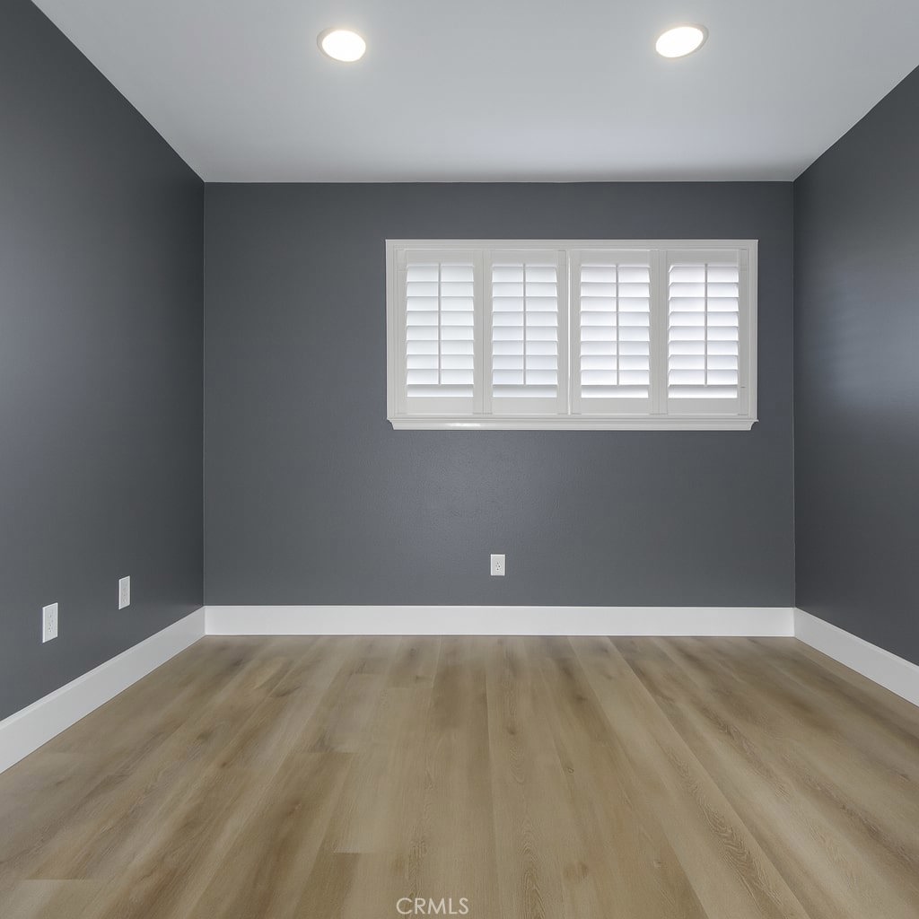 5114 West 1st Street, Unit C Santa Ana, CA 92703 - Photo 10 of 26 wooden floor in an empty room with a window