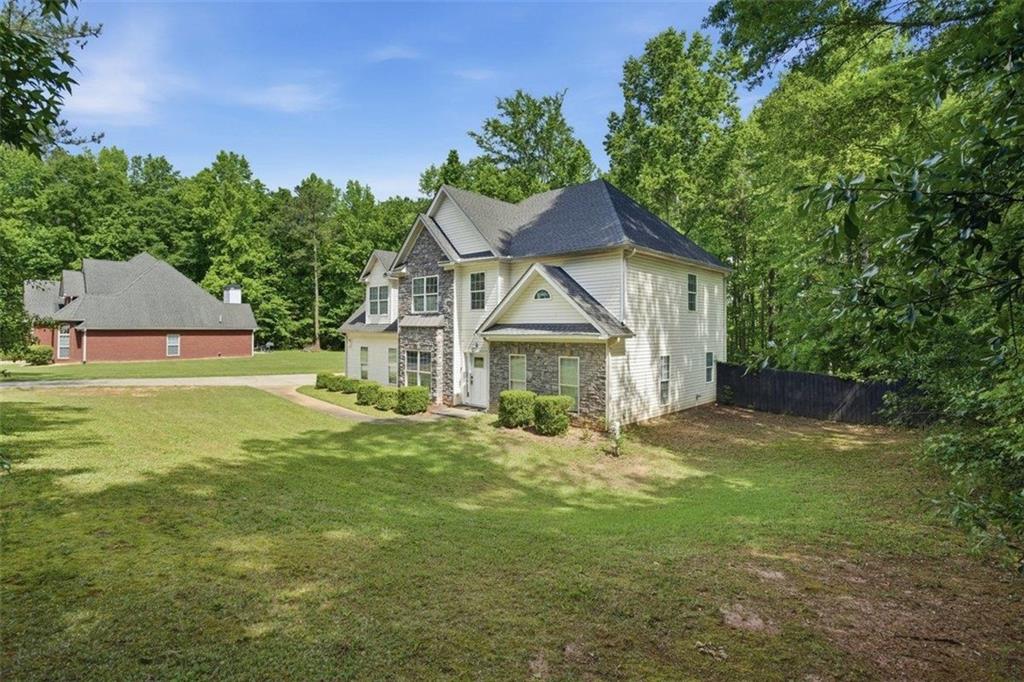 1231 Hillview Road Hampton, GA 30228 - Photo 34 of 49 a view of a house with a big yard and large trees