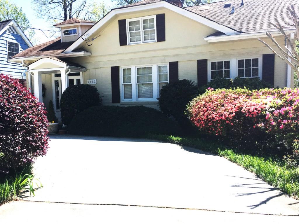 2111 Fairhaven Circle Northeast, Unit UPSTAI Atlanta, GA 30305 - Photo 1 of 16 a front view of a house with a garden