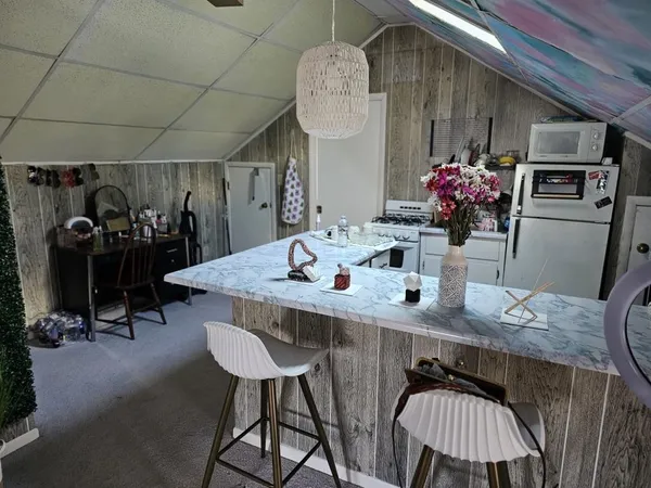 a view of a dining room with furniture and chandelier