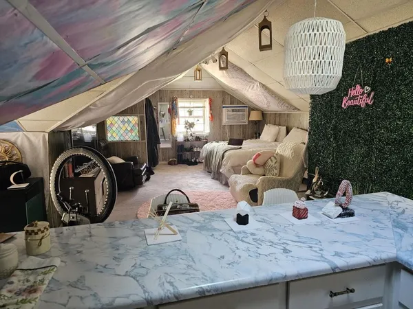 a bedroom with furniture and a flat screen tv