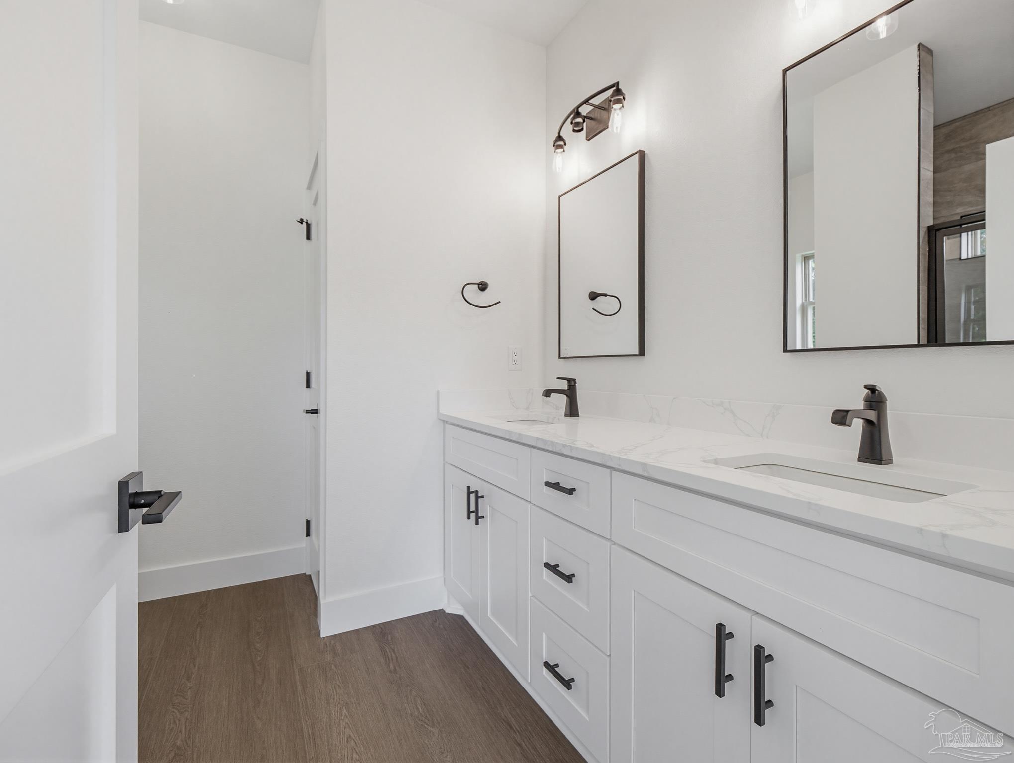 5724 Riviera Drive Milton, FL 32583 - Photo 26 of 52 a bathroom with double vanity sink and a mirror