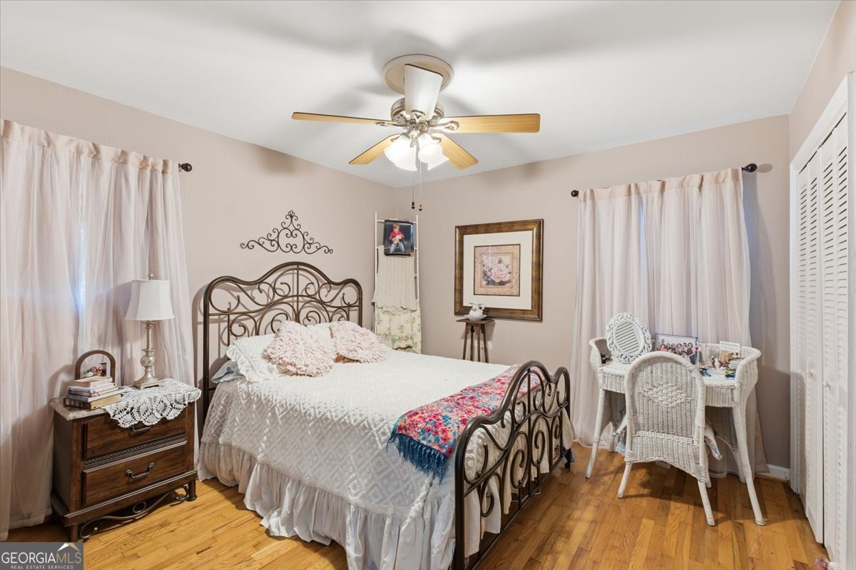 129 George West Road Cedartown, GA 30125 - Photo 22 of 36 a bedroom with a bed and a chandelier