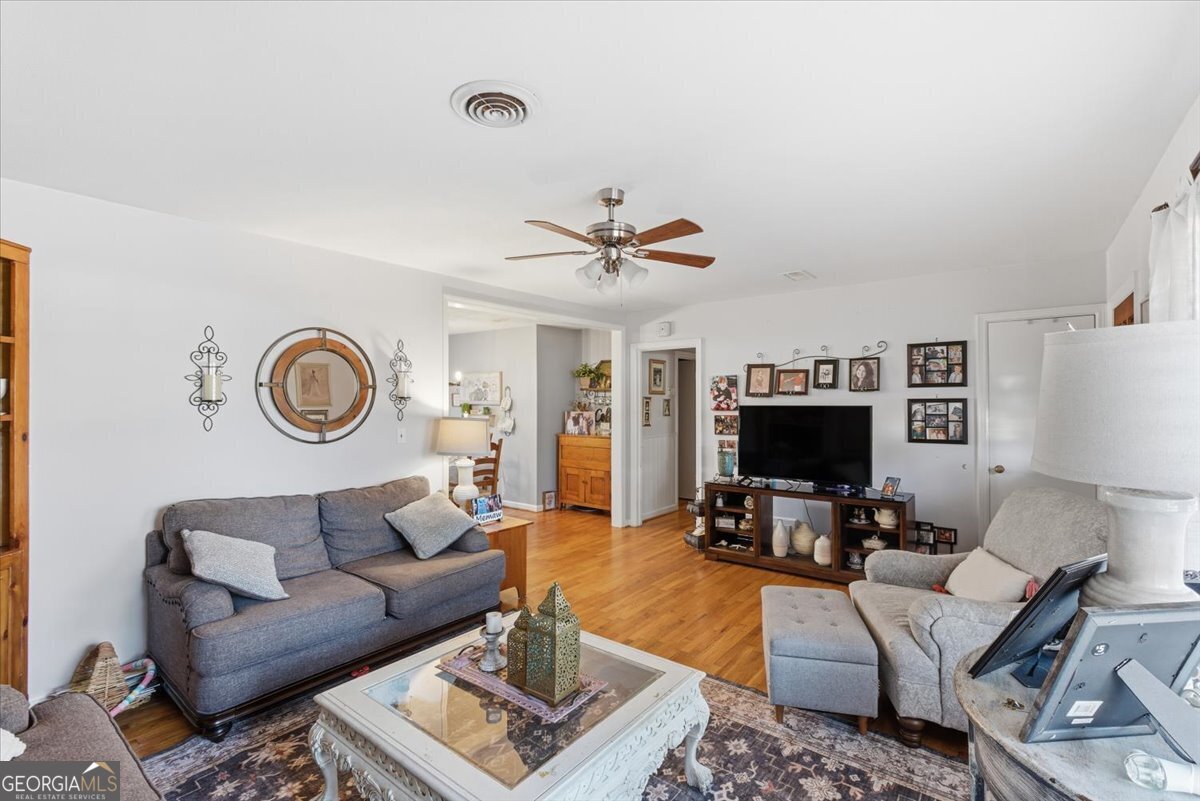 129 George West Road Cedartown, GA 30125 - Photo 10 of 36 a living room with furniture a fireplace and a flat screen tv