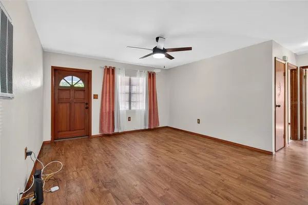 a kitchen with a stove cabinets and wooden floor